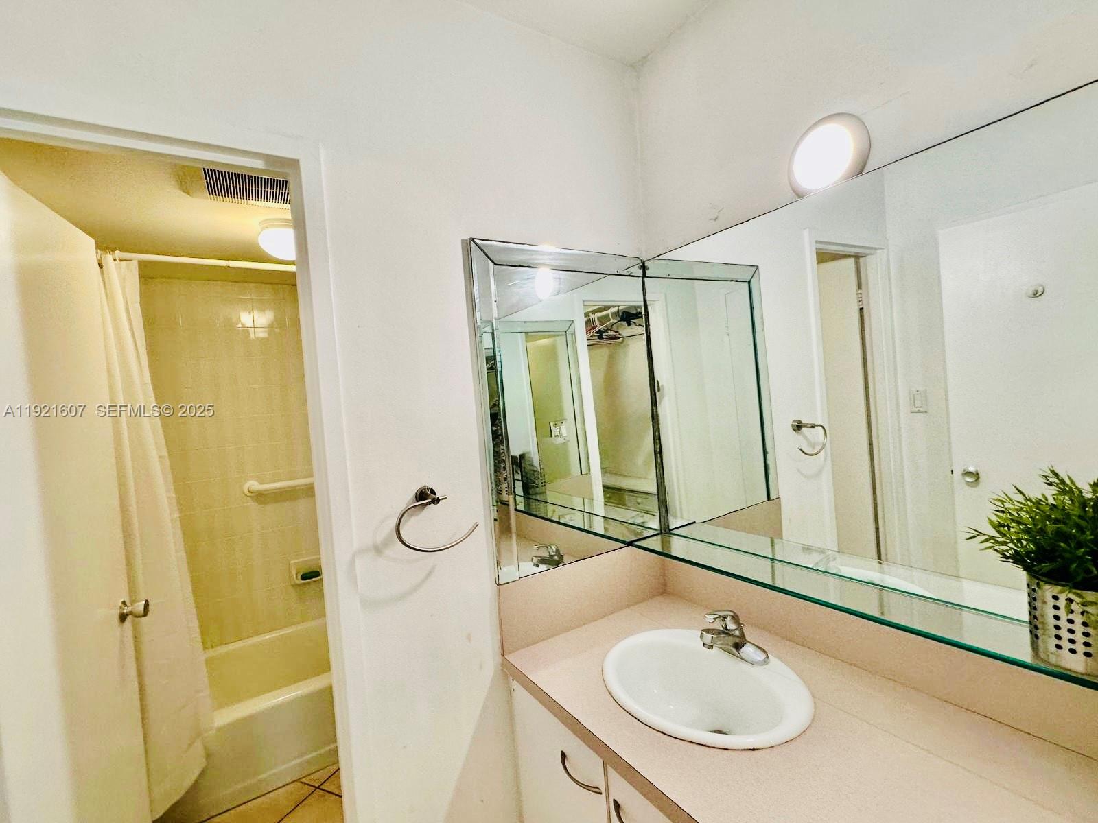 100 Lincoln Road, Unit 1427 Miami Beach, FL 33139 - Photo 25 of 32 a bathroom with a sink and a mirror