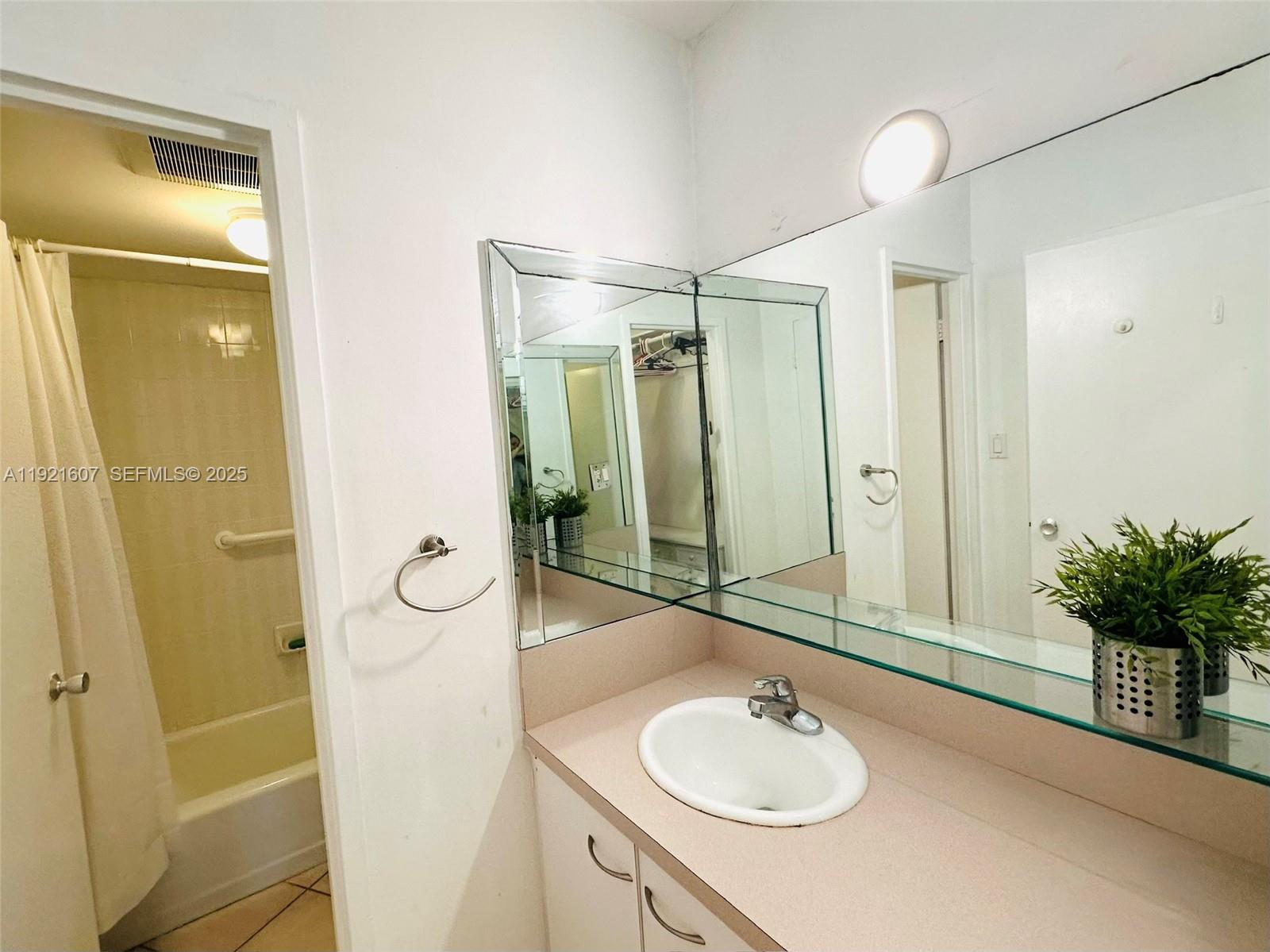 100 Lincoln Road, Unit 1427 Miami Beach, FL 33139 - Photo 26 of 32 a bathroom with a sink a toilet and shower