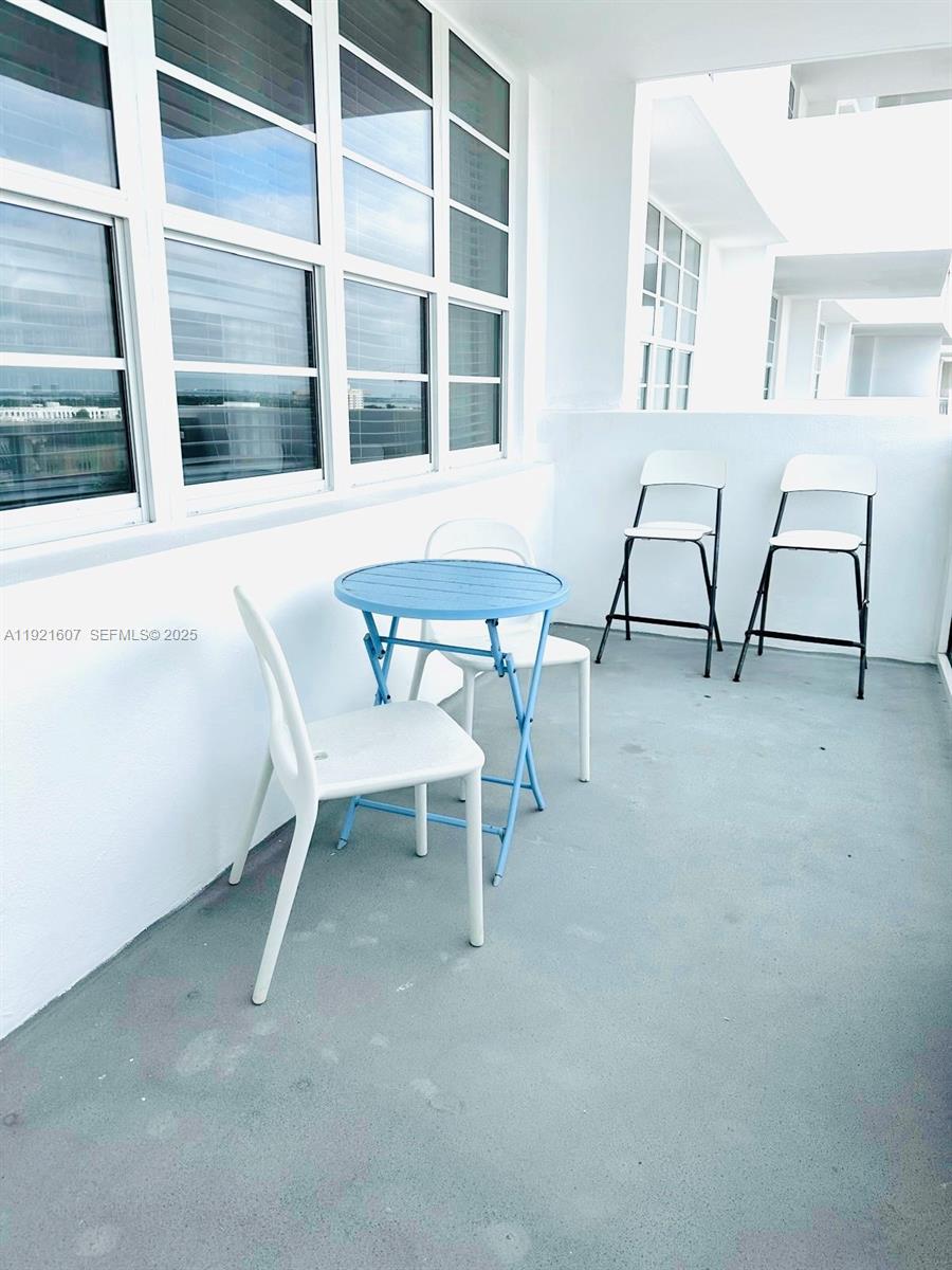 100 Lincoln Road, Unit 1427 Miami Beach, FL 33139 - Photo 31 of 32 a view of a room with a table and chairs