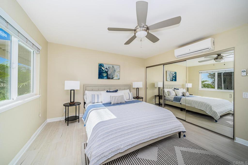 3801 Orange Way Oceanside, CA 92057 - Photo 34 of 52 a bedroom with a bed and wooden floor