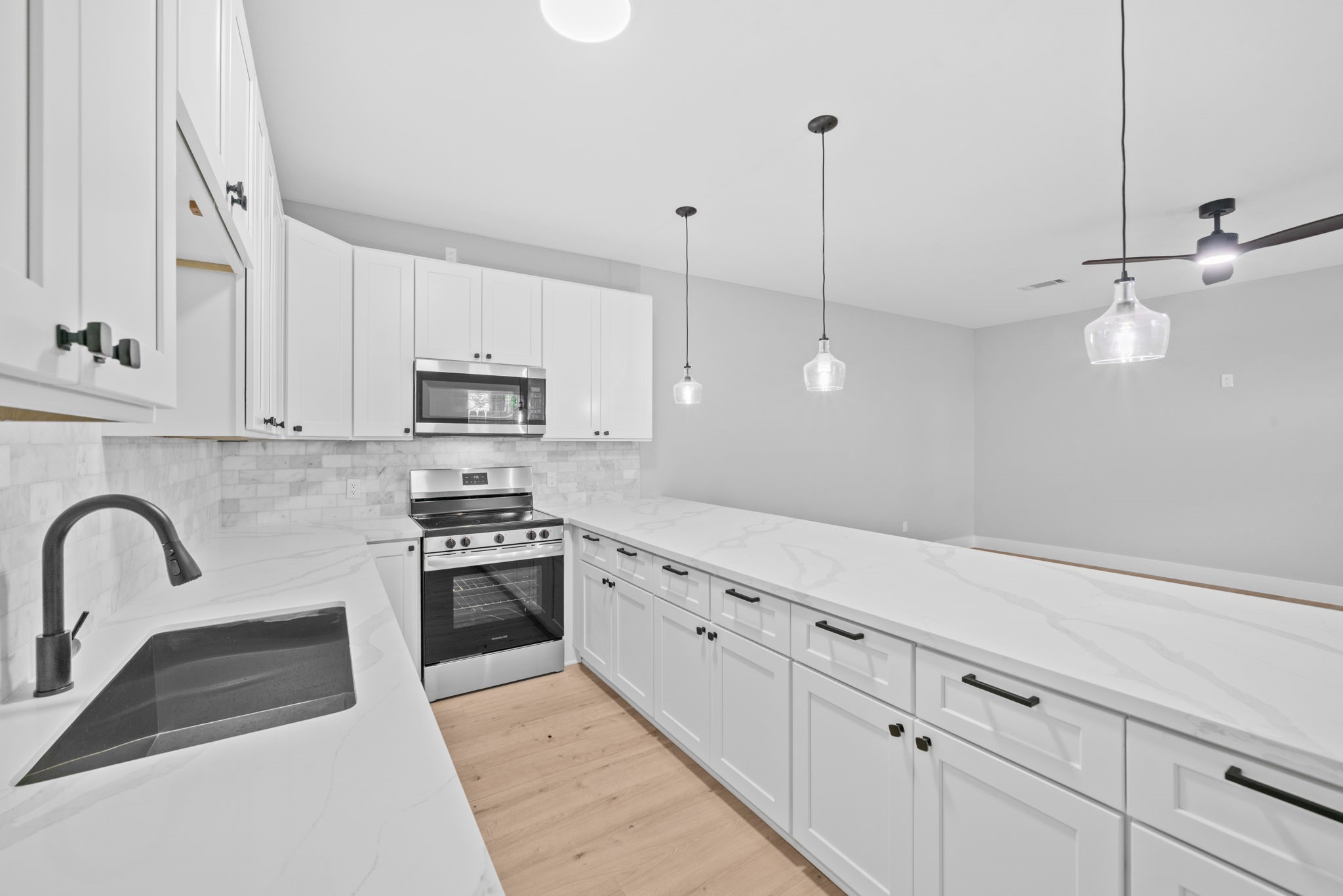 9918 Fillmore Street Houston, TX 77029 - Photo 12 of 35 a kitchen with white cabinets and stainless steel appliances