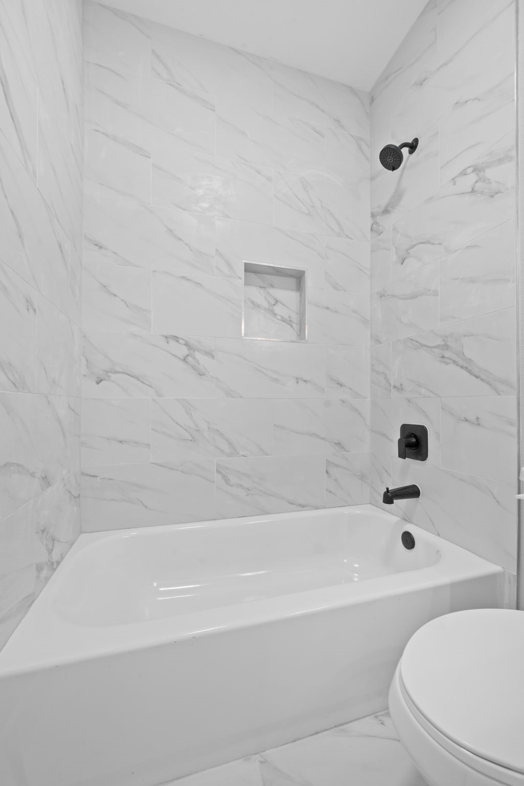 9918 Fillmore Street Houston, TX 77029 - Photo 18 of 35 a bathroom with a bathtub and a toilet