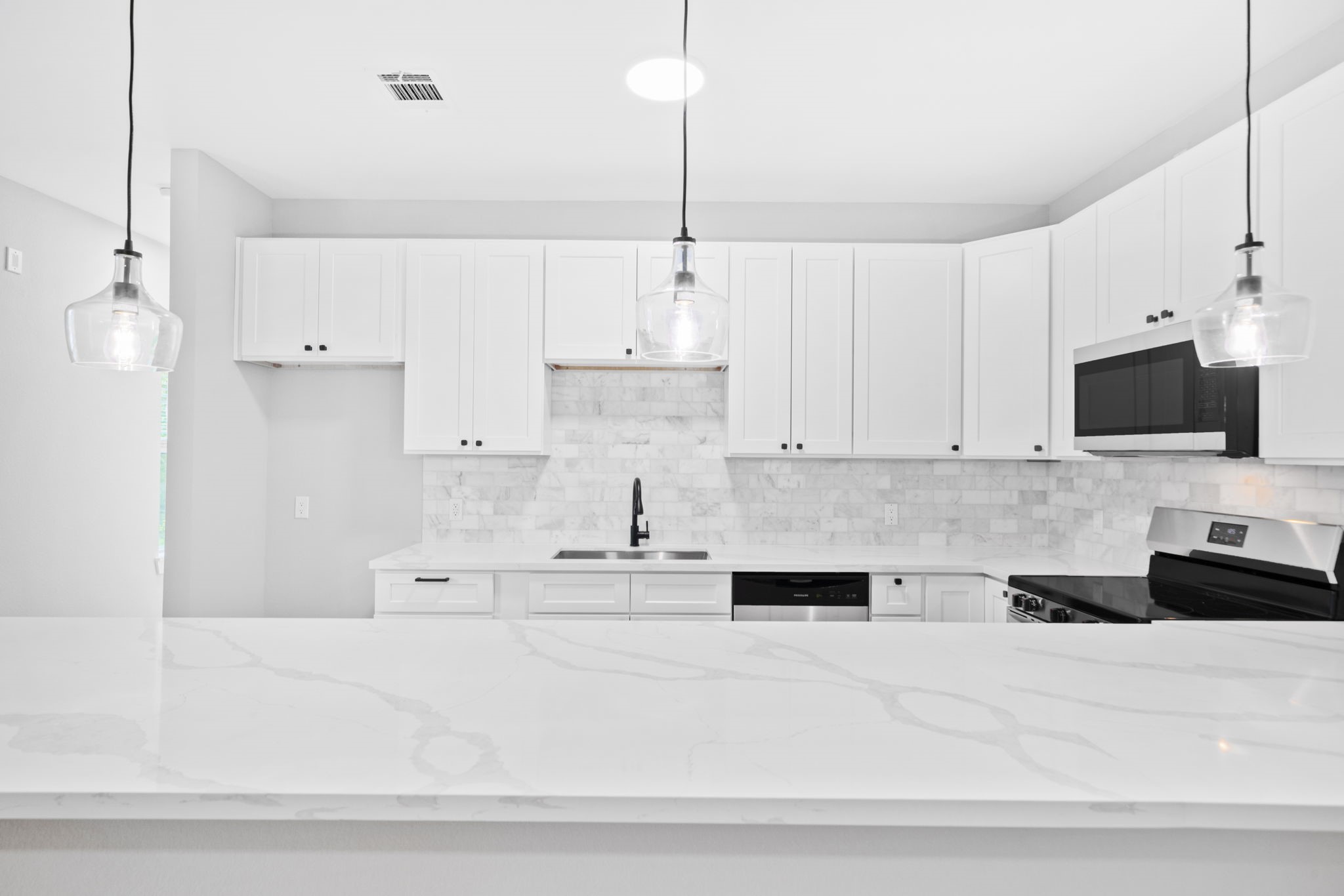 9918 Fillmore Street Houston, TX 77029 - Photo 26 of 35 a kitchen with stainless steel appliances kitchen island granite countertop white cabinets and black granite counter tops