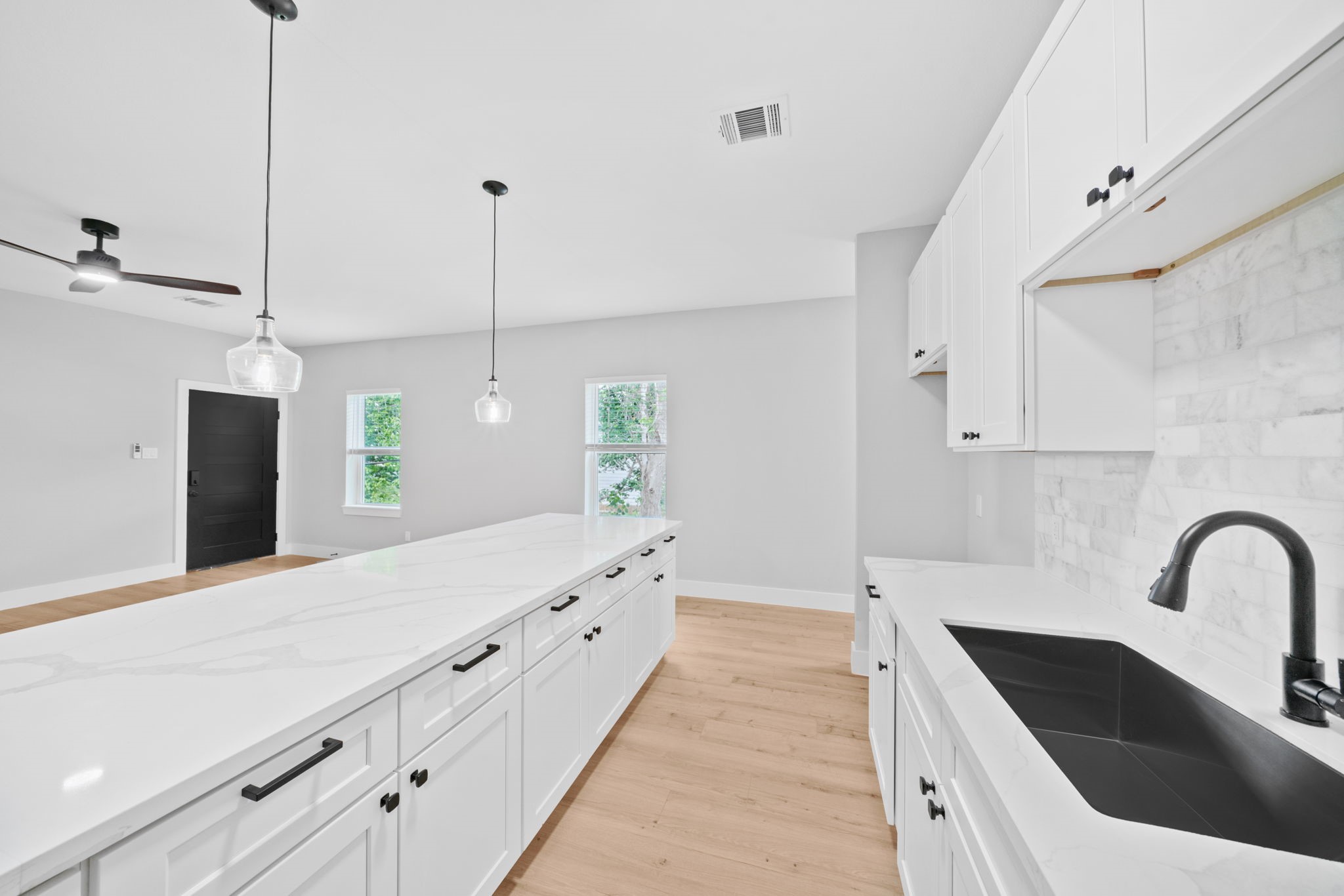 9918 Fillmore Street Houston, TX 77029 - Photo 28 of 35 a kitchen with stainless steel appliances kitchen island a white counter space a sink and cabinets