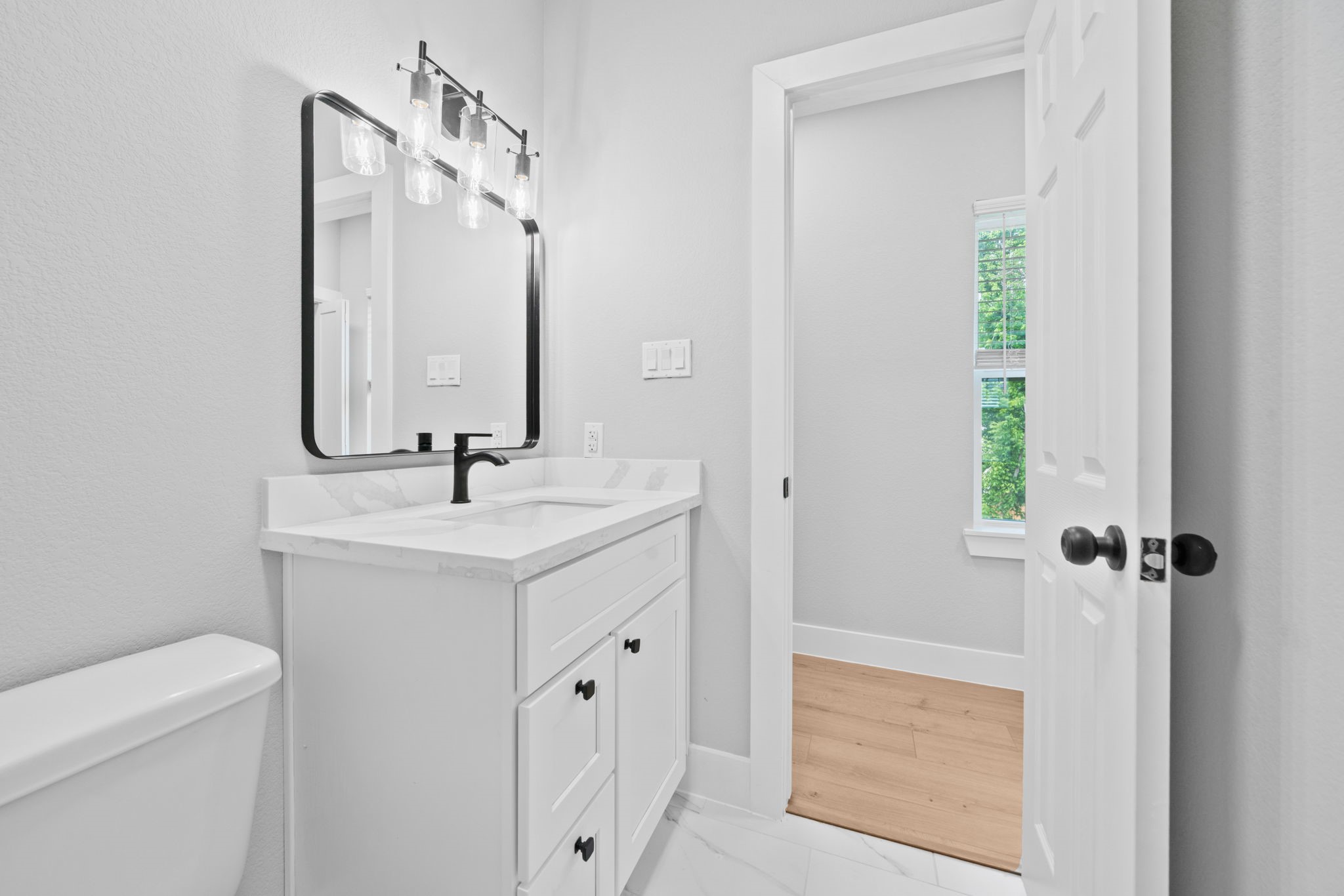 9918 Fillmore Street Houston, TX 77029 - Photo 33 of 35 a bathroom with a sink a toilet and a mirror