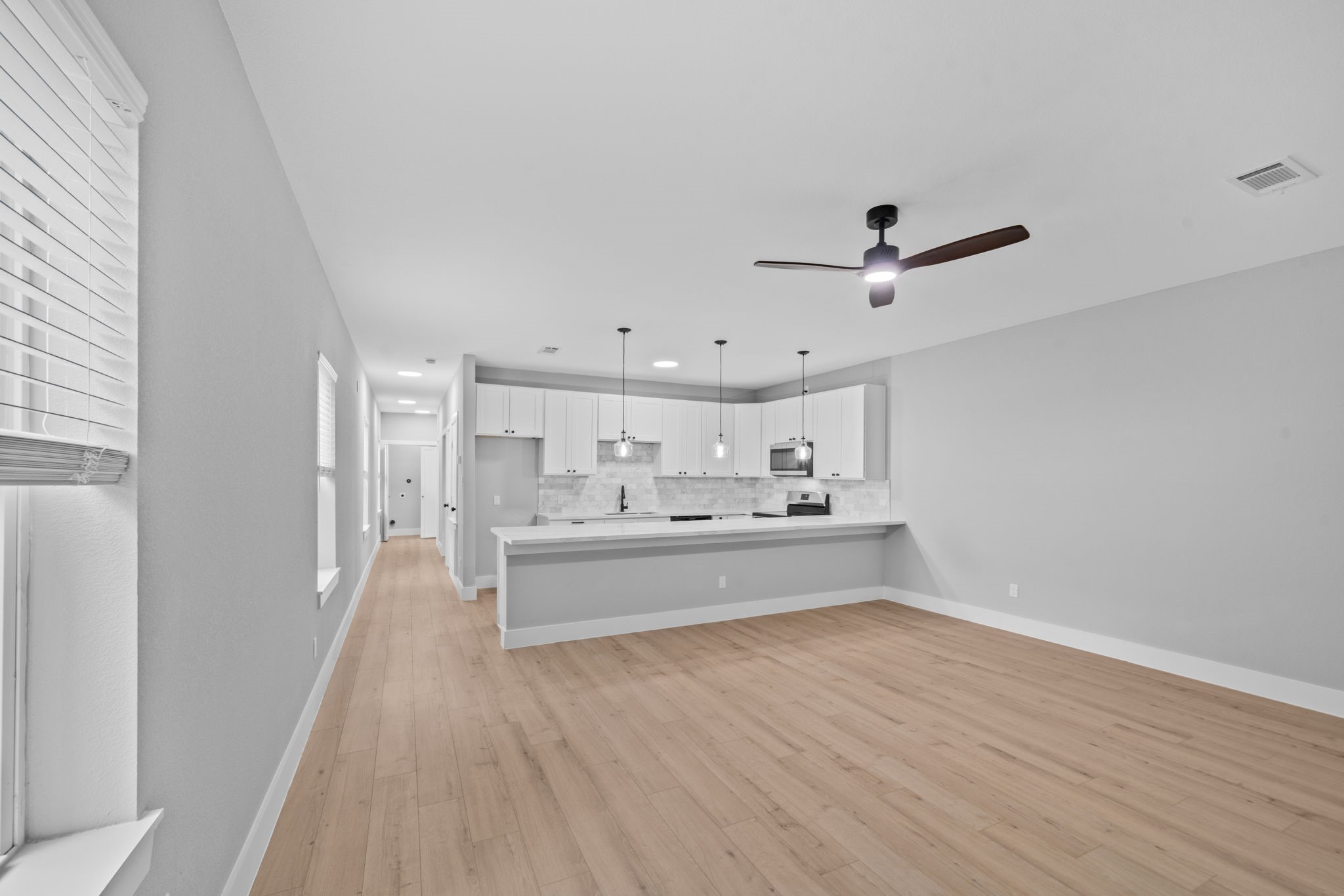 9918 Fillmore Street Houston, TX 77029 - Photo 5 of 35 a view of kitchen with sink and wooden floor
