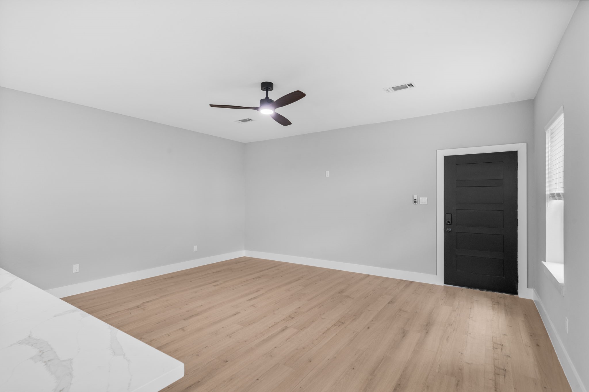 9918 Fillmore Street Houston, TX 77029 - Photo 6 of 35 a view of an empty room with wooden floor and a ceiling fan