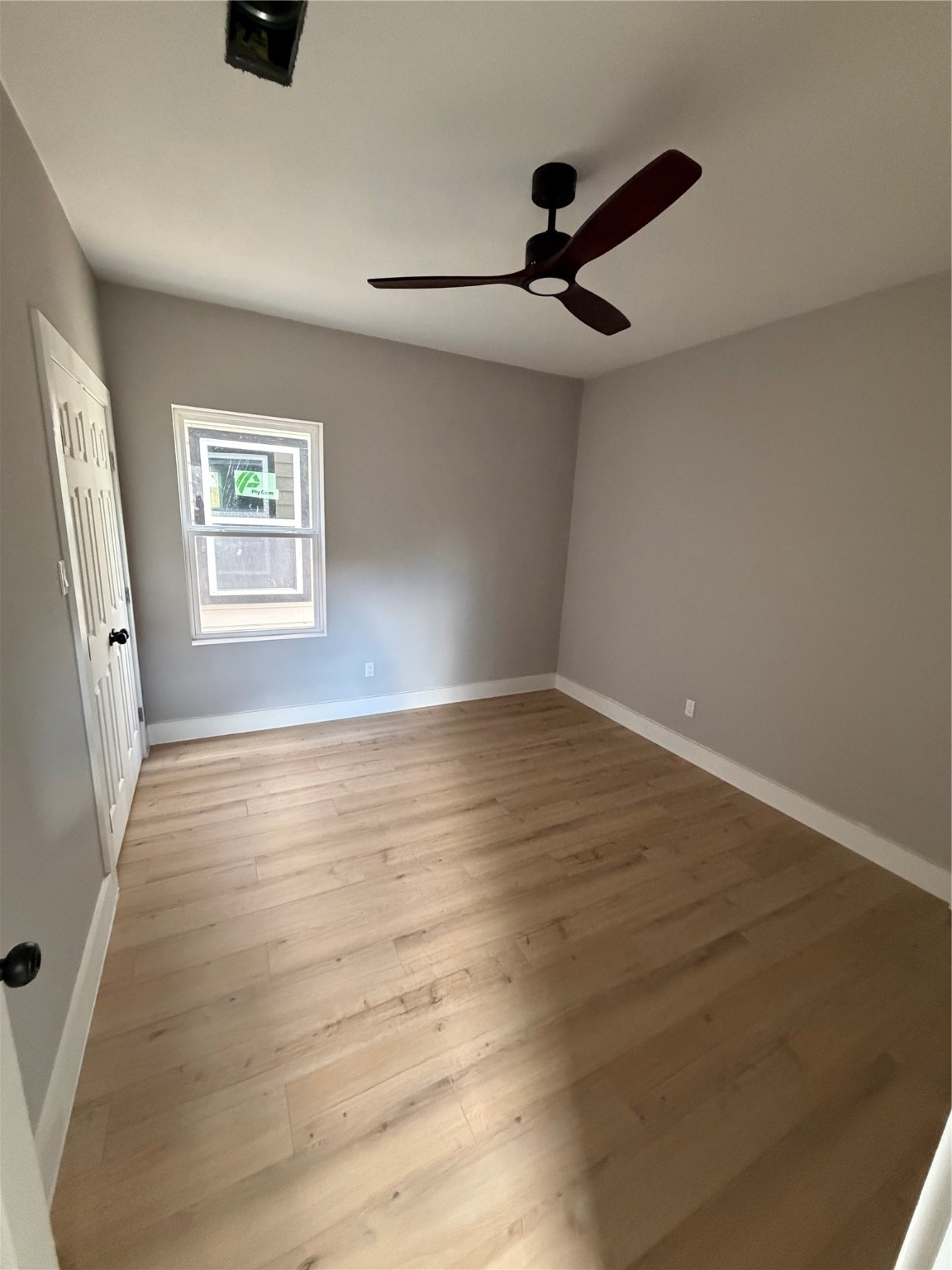 9918 Fillmore Street Houston, TX 77029 - Photo 9 of 11 wooden floor in an empty room with a window