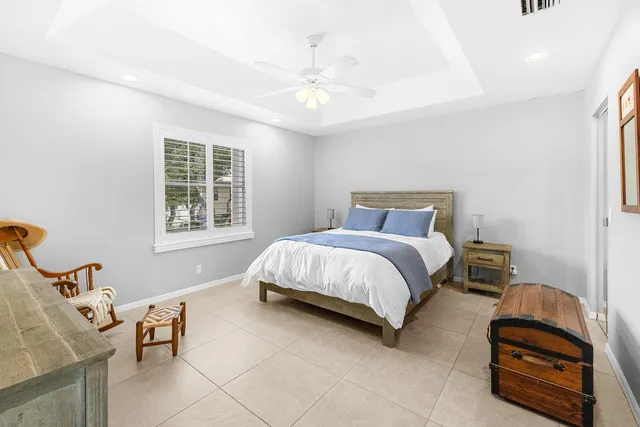 a spacious bedroom with a bed and glass window