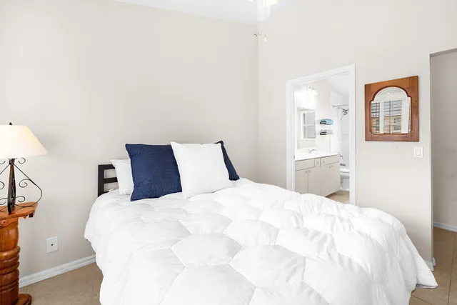 a large bed sitting in a bedroom next to a window