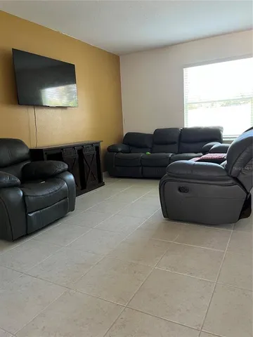 a living room with furniture and a window
