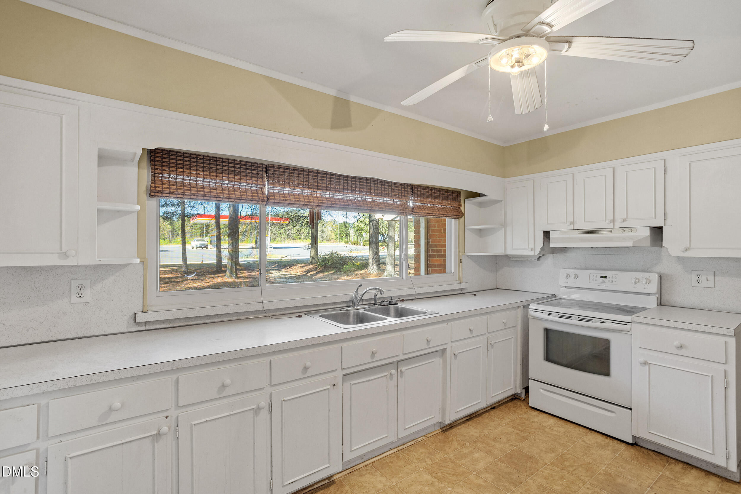 5011 Old Stage Road Raleigh, NC 27603 - Photo 14 of 29 a kitchen with a sink window and cabinets