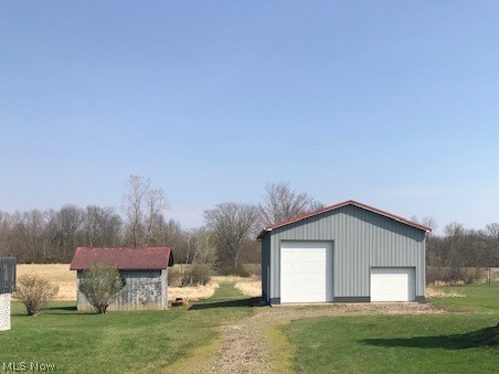 9643 Tallmadge Road Diamond, OH 44412 - Photo 7 of 35 24 x40 metal barn with 14" ceilings and 12" door. Concrete floor, oil heater and work benches... this is a year round toy box! The Shed is raised with a wood floor and has a lot of promise to be a party shed or another shed for yard equipment... endless possibilities!