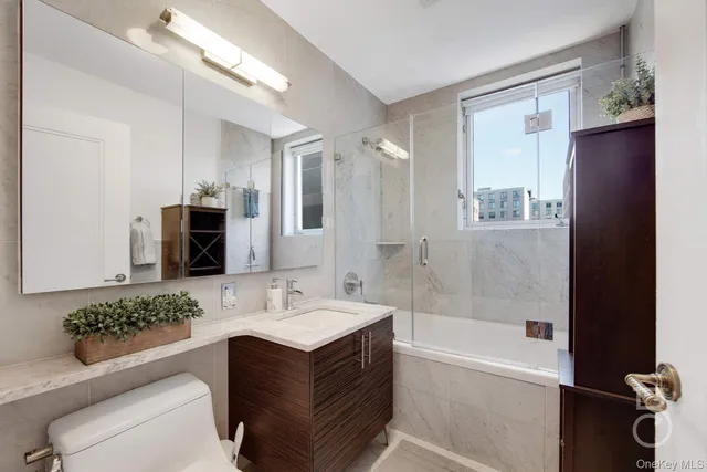 a bathroom with a tub sink and mirror