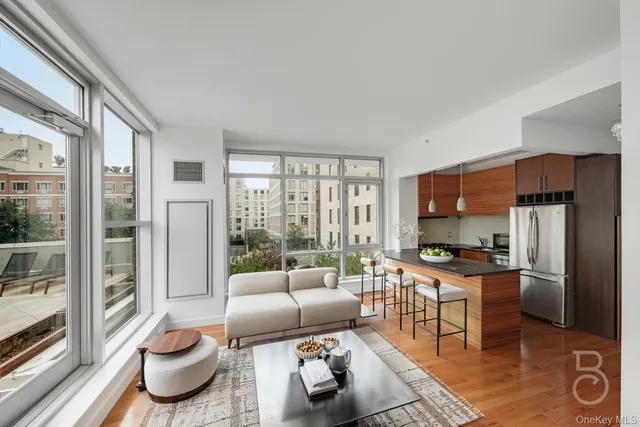 a living room with furniture and a floor to ceiling window