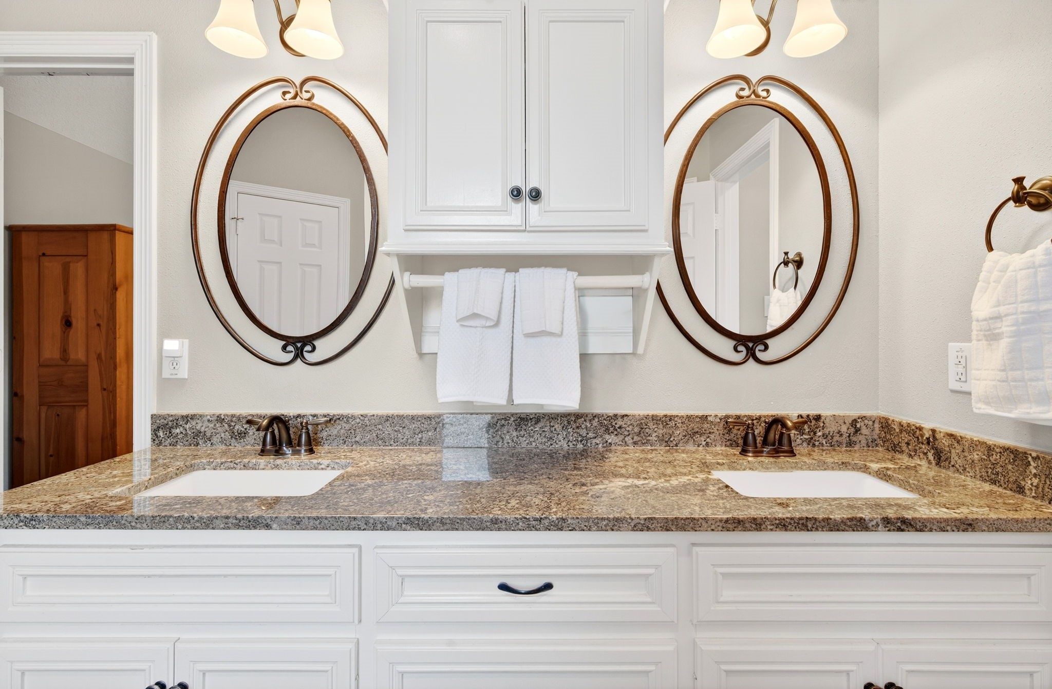 23620 Spring Branch Trail Montgomery, TX 77316 - Photo 13 of 27 The vanity features granite counters, dual sinks, designer double mirrors, and added cabinetry for effortless storage.