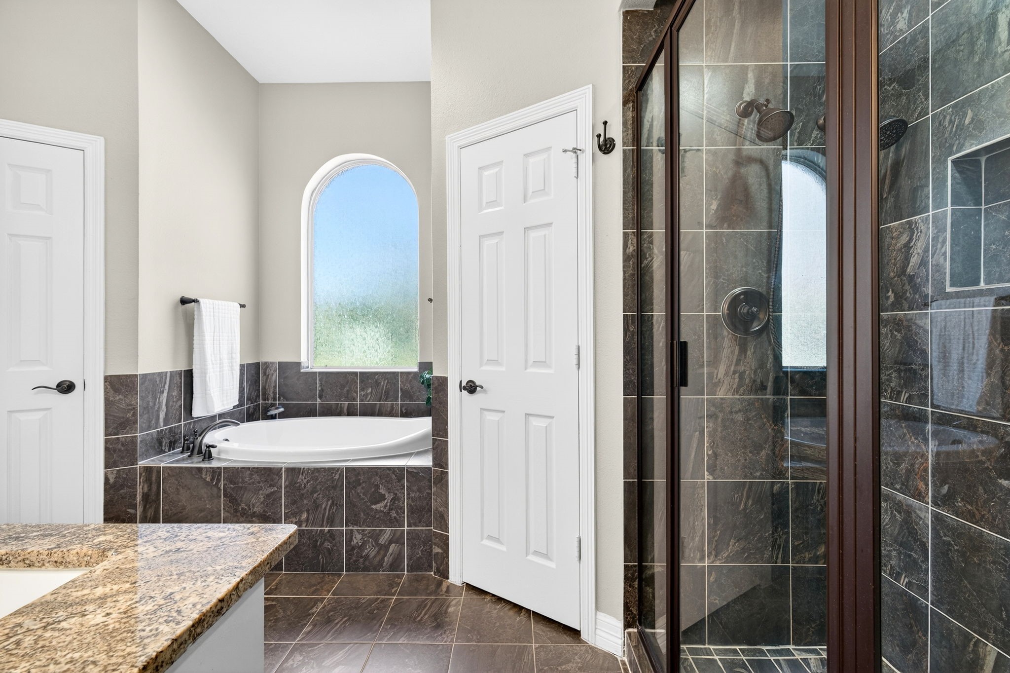 23620 Spring Branch Trail Montgomery, TX 77316 - Photo 14 of 27 The bath continues boasts a walk-in shower with tile surround and a private water closet.