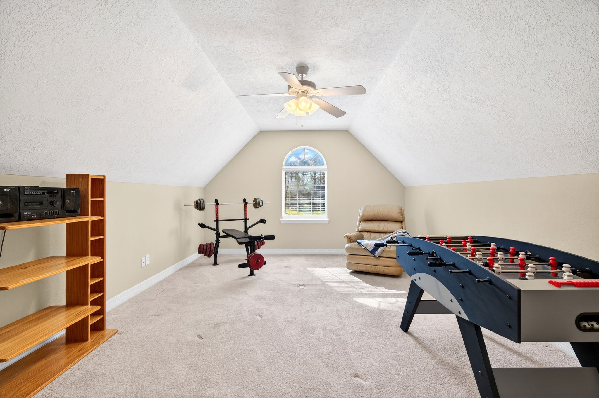 23620 Spring Branch Trail Montgomery, TX 77316 - Photo 20 of 27 Upstairs, a bright bonus room welcomes play, media, or hobbies, with access to decked attic storage.