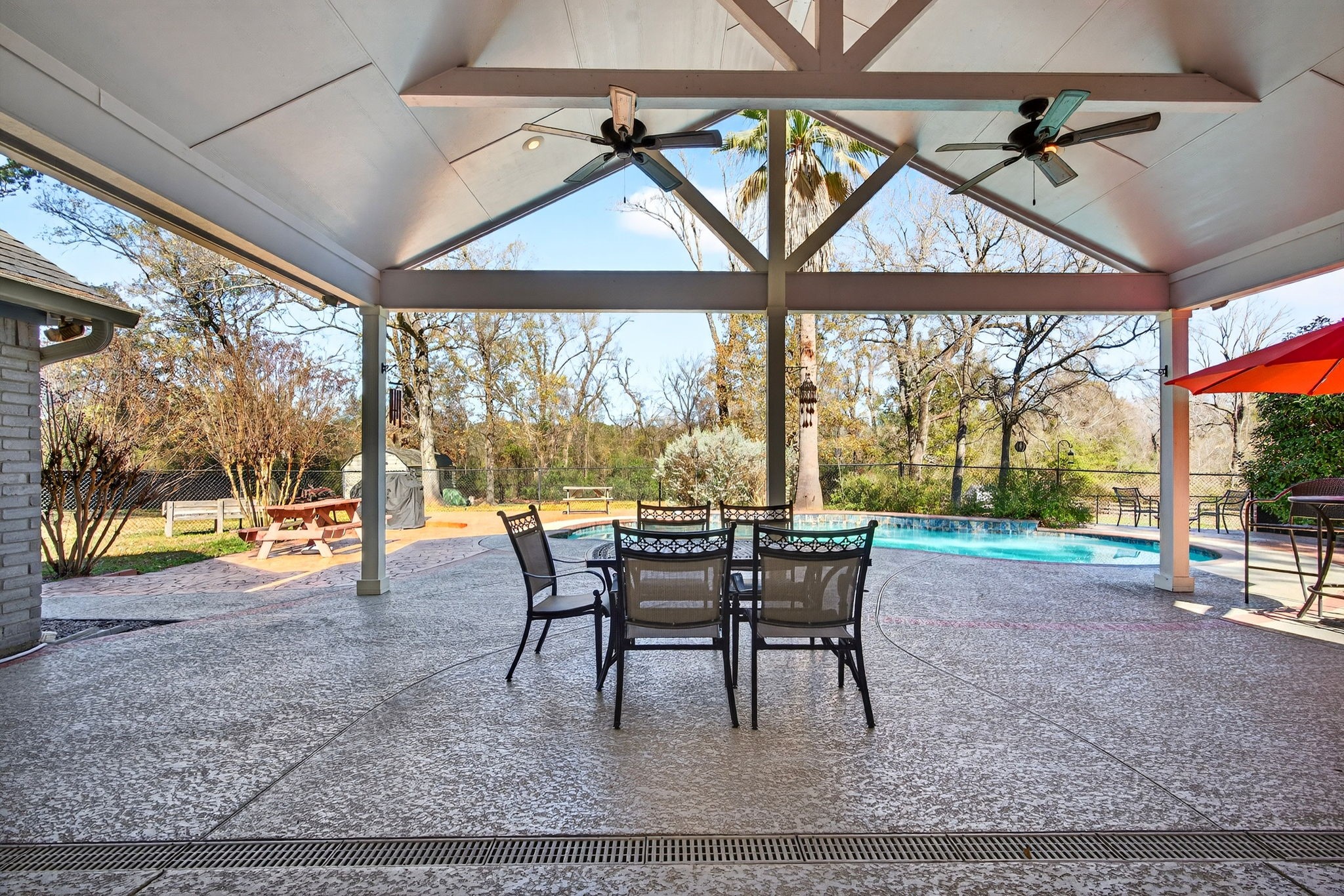 23620 Spring Branch Trail Montgomery, TX 77316 - Photo 21 of 27 Outdoor living shines with a covered patio, vaulted ceiling, fully fenced pool area, and a sweep of backyard—no rear neighbors for added privacy.