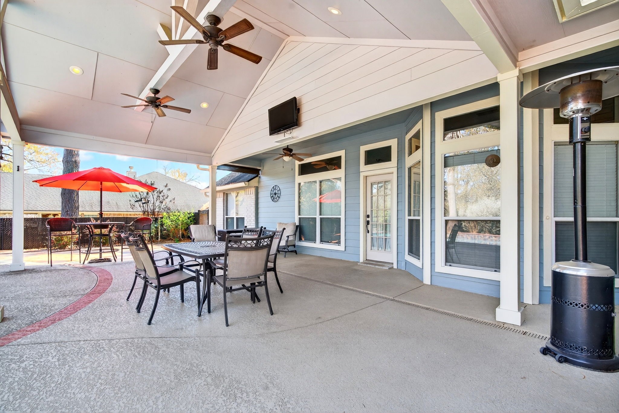 23620 Spring Branch Trail Montgomery, TX 77316 - Photo 22 of 27 Multiple windows blur the line between indoors and out, while three patio fans and a mounted TV make entertaining effortless year-round.