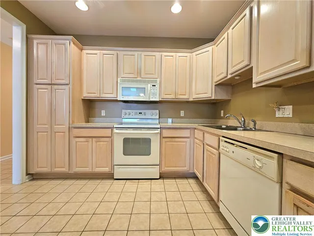 a kitchen with a sink a stove and cabinets