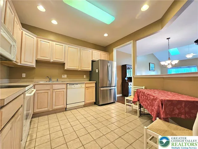 a kitchen with a sink a refrigerator and cabinets