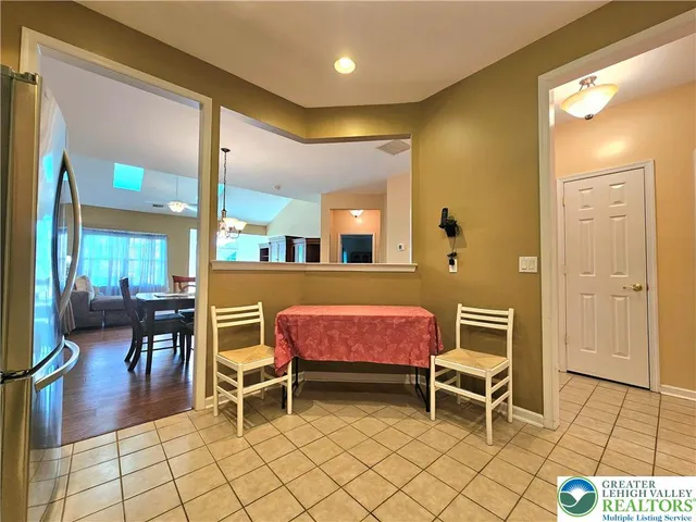 a room with furniture a rug and a view of living room