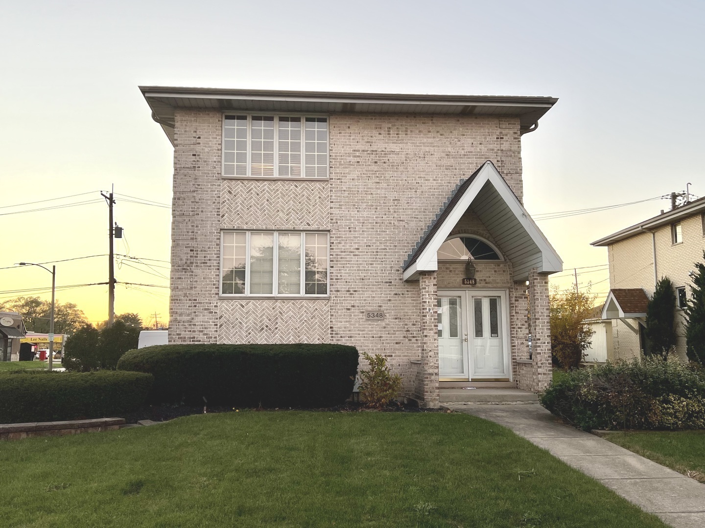 5348 6th Avenue, Unit 1 Countryside, IL 60525 - Photo 1 of 4 a front view of a house with garden