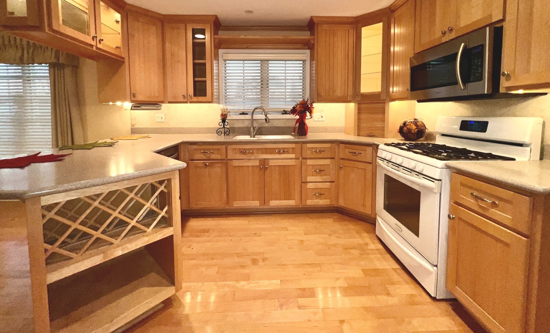 5348 6th Avenue, Unit 1 Countryside, IL 60525 - Photo 3 of 4 a kitchen with stainless steel appliances granite countertop a stove a sink and a microwave