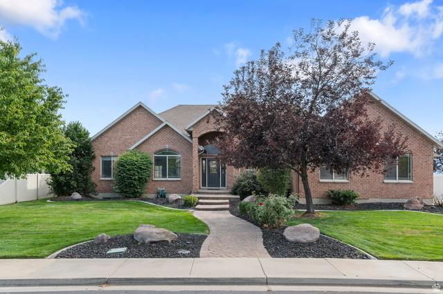 1501 West Elk Circle Mapleton, UT 84664 - Photo 2 of 39 Brick exterior residence featuring a covered entry, arched window, and multiple rectangular windows