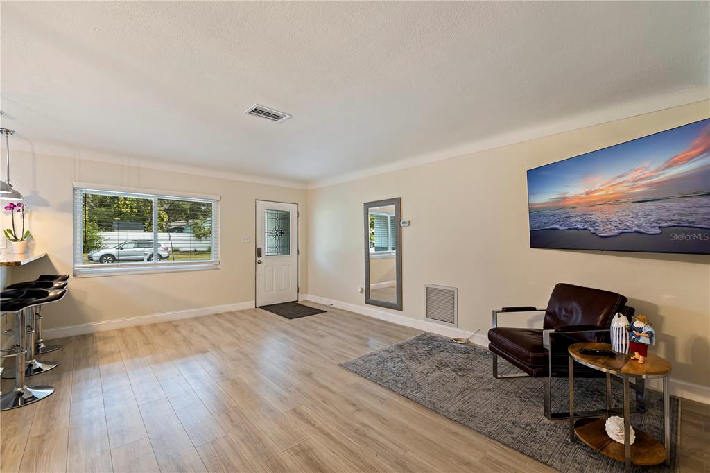 3282 Honeysuckle Road Largo, FL 33770 - Photo 12 of 44 a living room with furniture and a flat screen tv