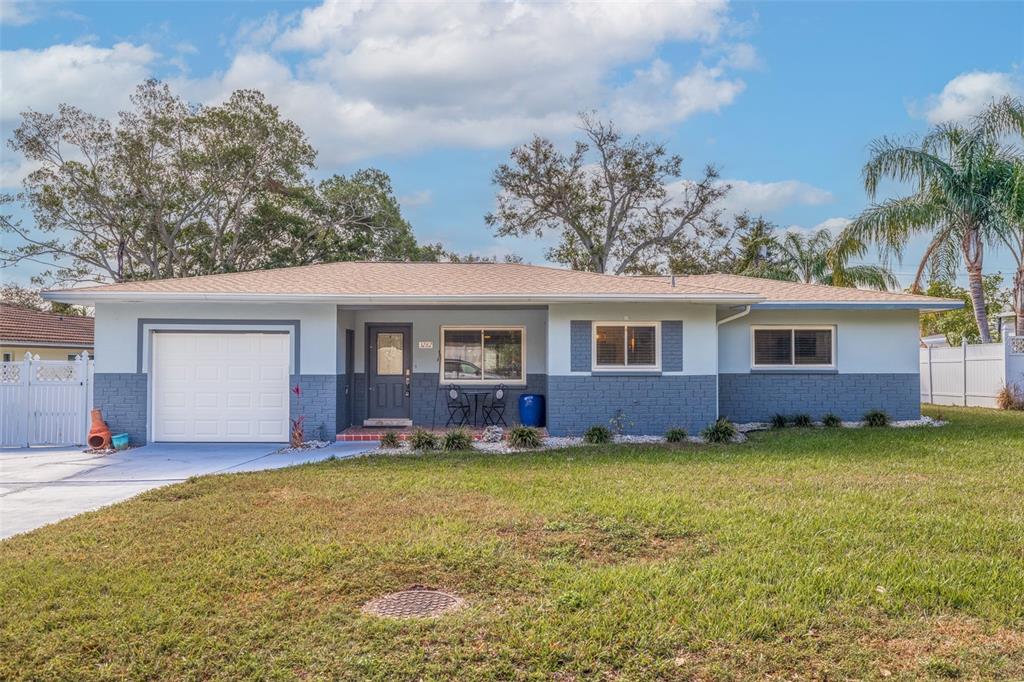 3282 Honeysuckle Road Largo, FL 33770 - Photo 2 of 44 a view of a house with a yard and garage