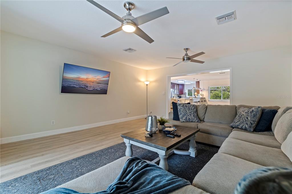 3282 Honeysuckle Road Largo, FL 33770 - Photo 22 of 44 a living room with furniture a chandelier and a window