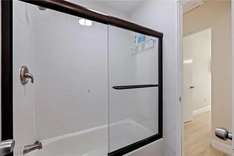 a bathroom with a shower and a bath tub