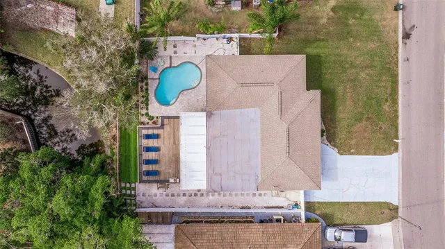 aerial view of a house with outdoor space and parking