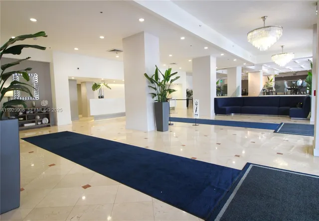 a view of living room with wooden floor and potted plant