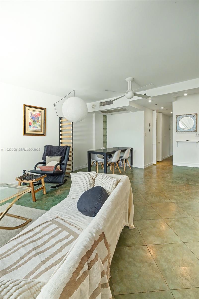 100 Lincoln Road, Unit 1515 Miami Beach, FL 33139 - Photo 6 of 23 a living room with furniture and a chandelier