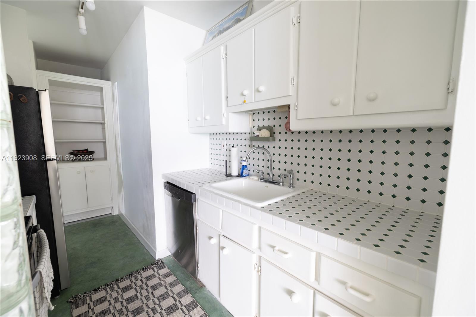 100 Lincoln Road, Unit 1515 Miami Beach, FL 33139 - Photo 7 of 23 a kitchen with granite countertop a sink a stove a refrigerator and cabinets