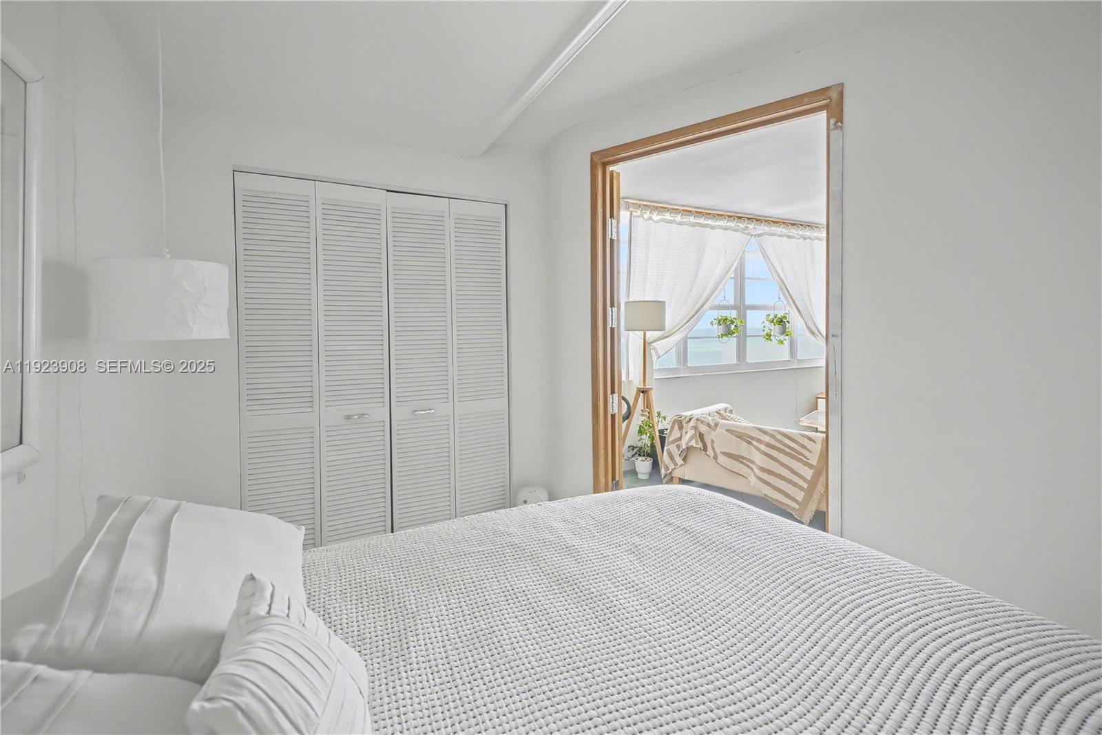 100 Lincoln Road, Unit 1515 Miami Beach, FL 33139 - Photo 9 of 23 a bedroom with a bed and a window
