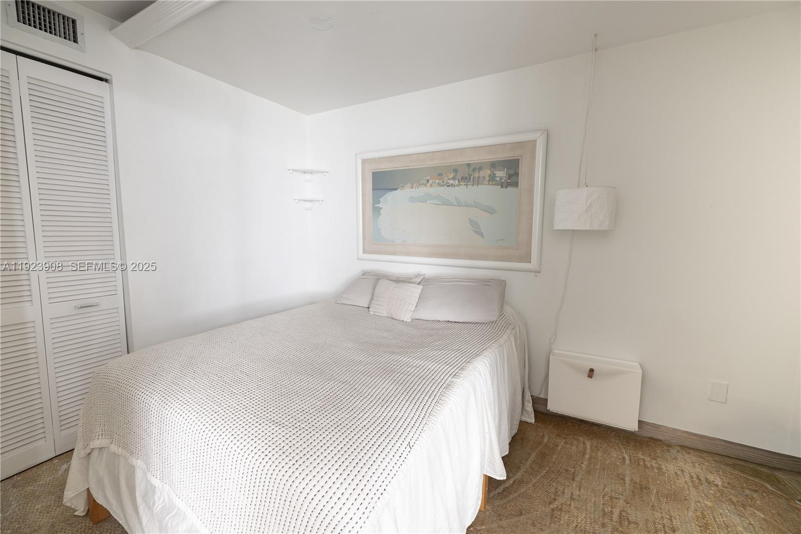 100 Lincoln Road, Unit 1515 Miami Beach, FL 33139 - Photo 10 of 23 a bedroom with a bed and a mirror
