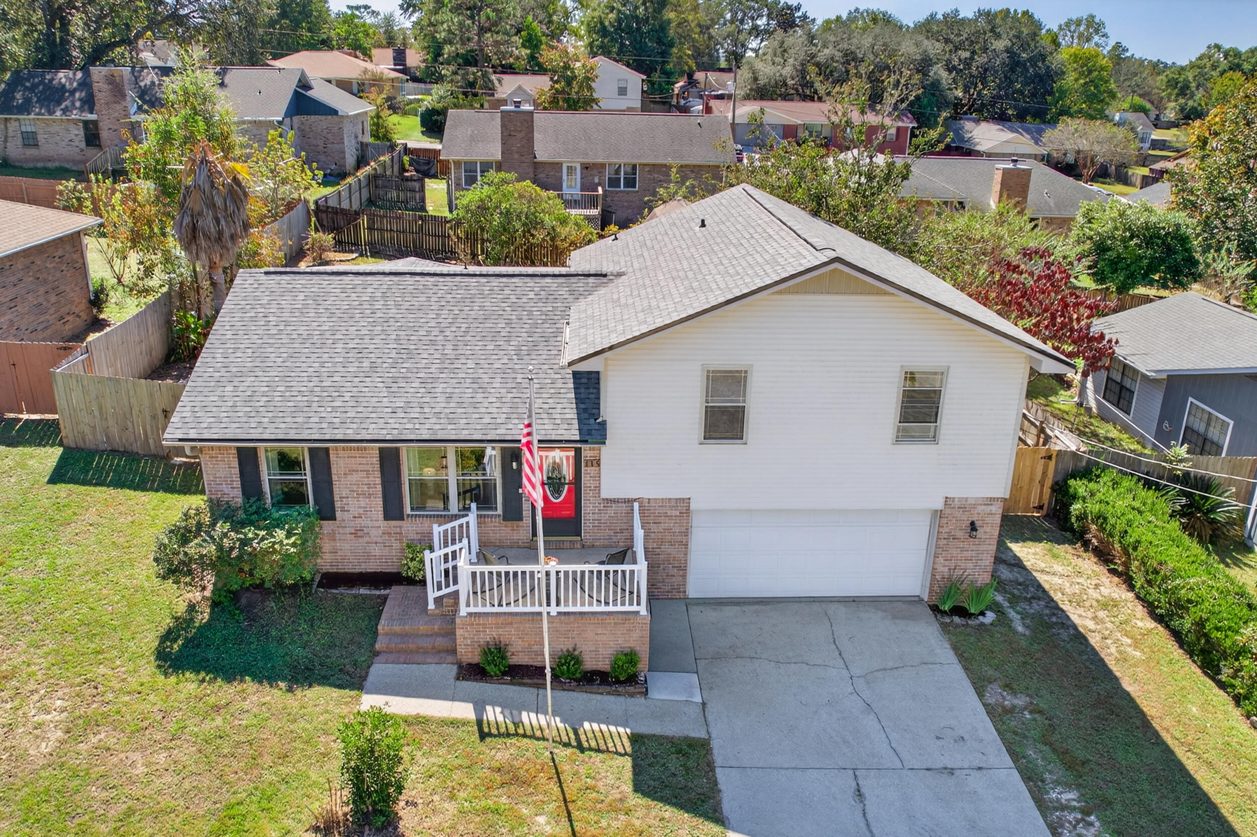 a aerial view of a house with a yard and potted plants