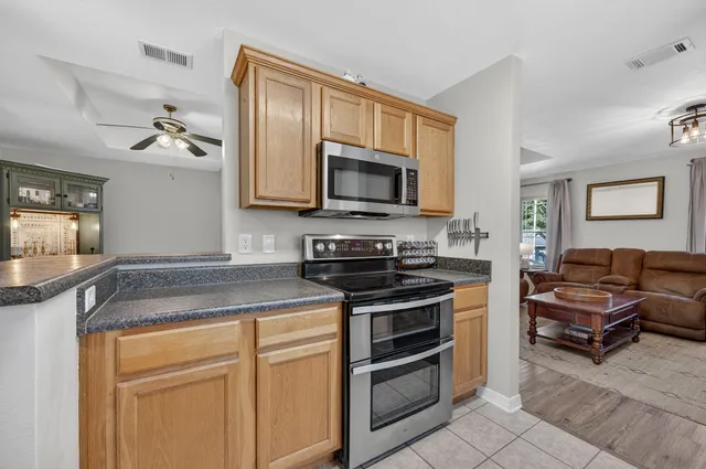 a bathroom with a granite countertop toilet sink and mirror