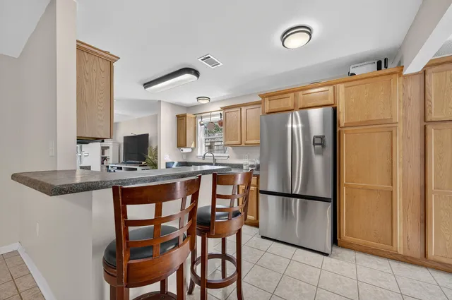 a living room with furniture a rug and a floor to ceiling window