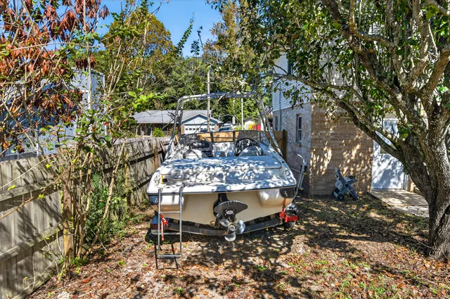 a view of a brick house with many windows and plants