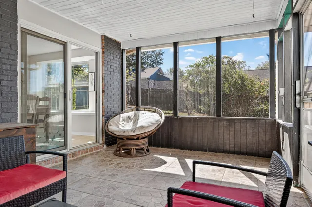 a view of a house with backyard porch and sitting area
