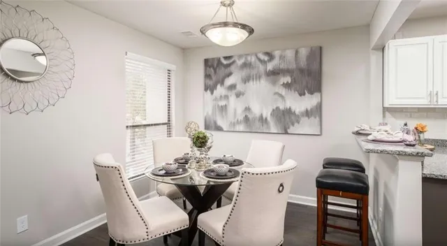 a view of a dining room with furniture and wooden floor