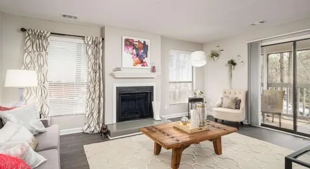 a living room with furniture and a fireplace