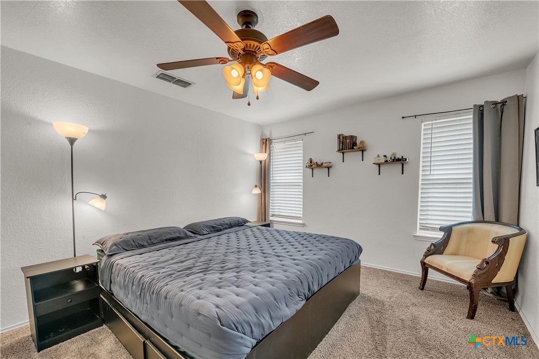 2002 Basalt Drive Killeen, TX 76549 - Photo 6 of 15 a bedroom with a bed and a chandelier