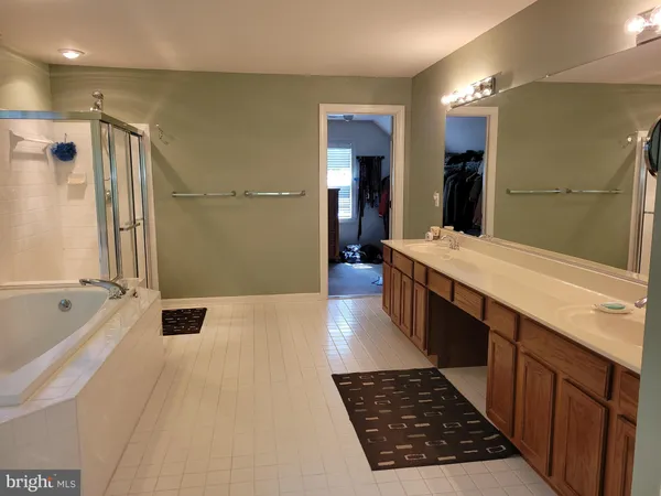 a bathroom with a sink a mirror and a bathtub