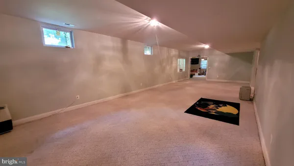 a bathroom with a granite countertop toilet and a shower